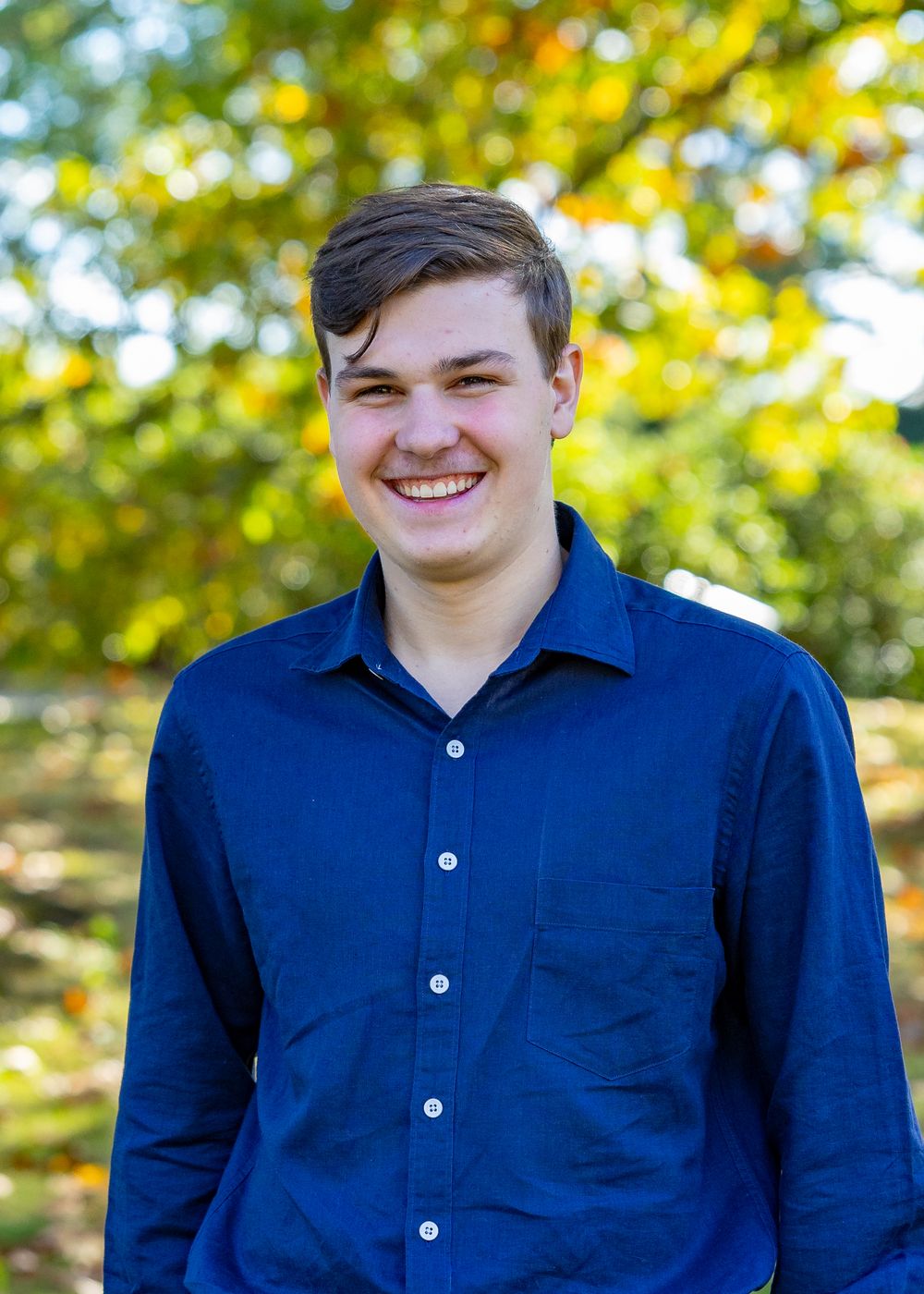 High School Senior poses for his yearbook photos at Old North Bridge in Concord, MA in Metrowest of Boston with Lisa West Photography.
