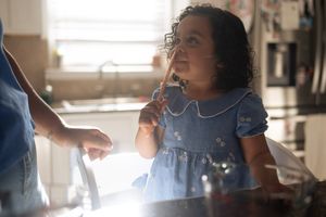Candid moments captured through window reflections in natural light.