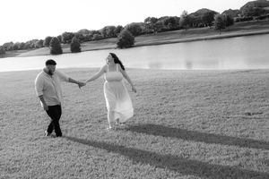 Black and white photo of people walking across an open field.