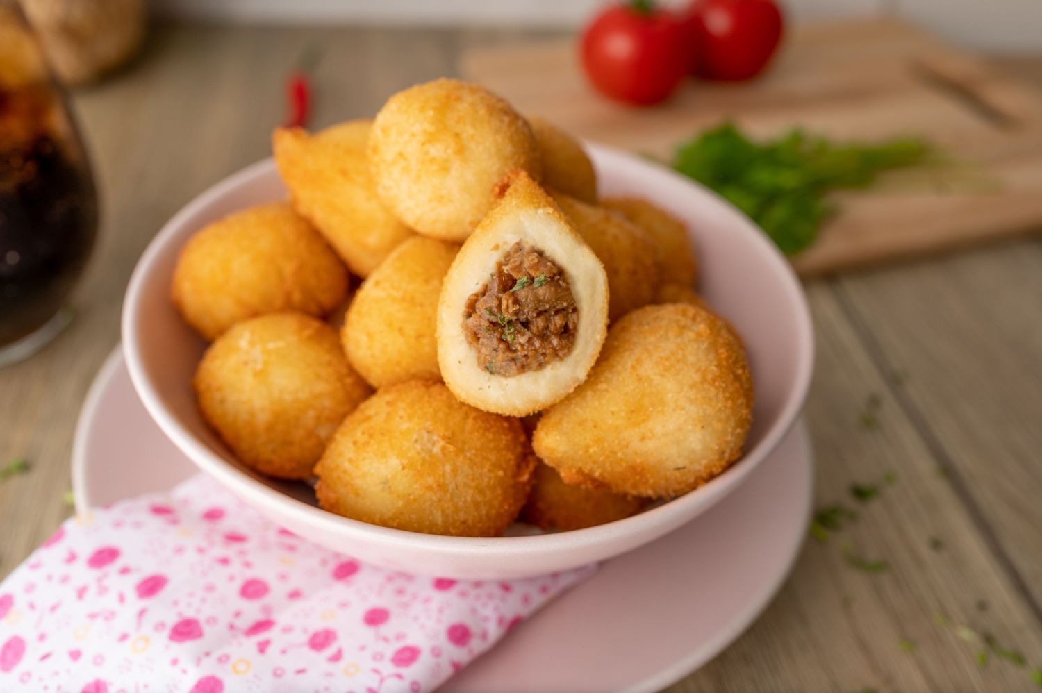 Crispy breaded appetizers arranged on a pink and white polka dot napkin.