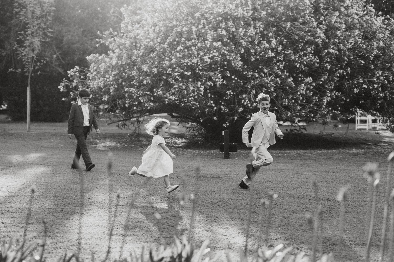 A black and white panoramic photograph shows people playing croquet in a garden setting during what appears to be the 1920s.
