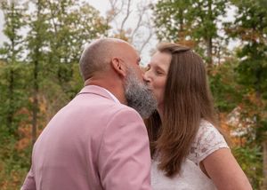 Emotional wedding ceremony moment captured in natural outdoor setting.