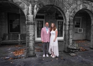 Stone archway entrance in black and white with couple in color.