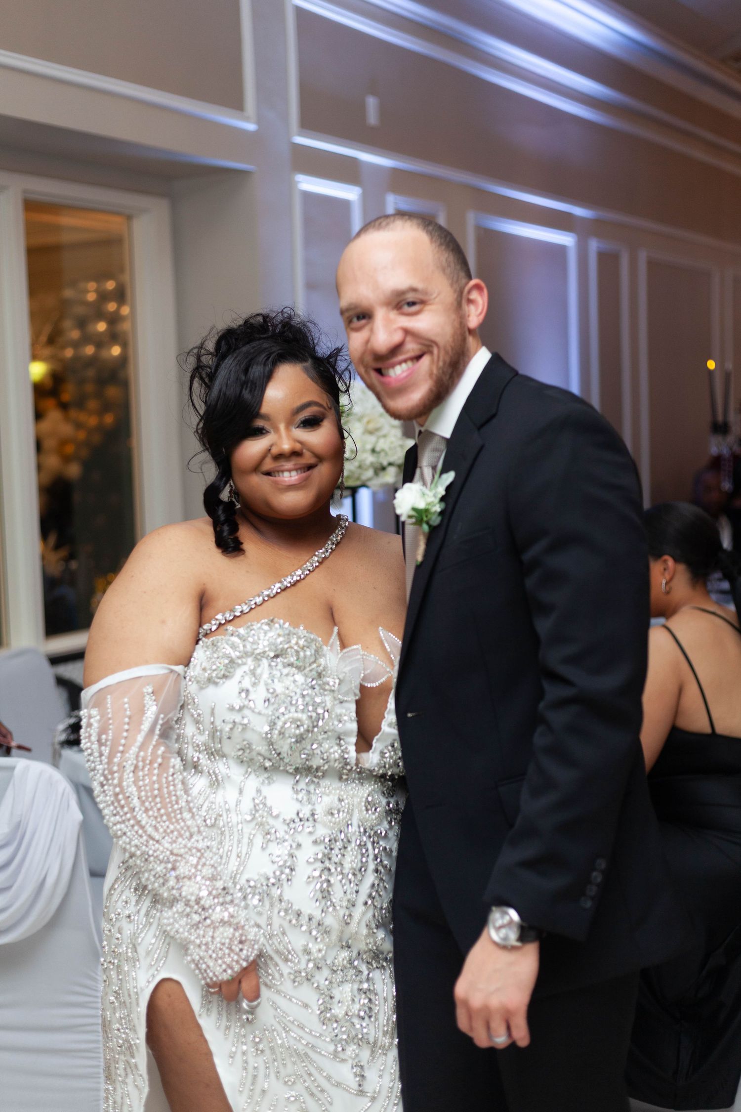A wedding couple shares a joyful moment on the dance floor at their elegant reception.