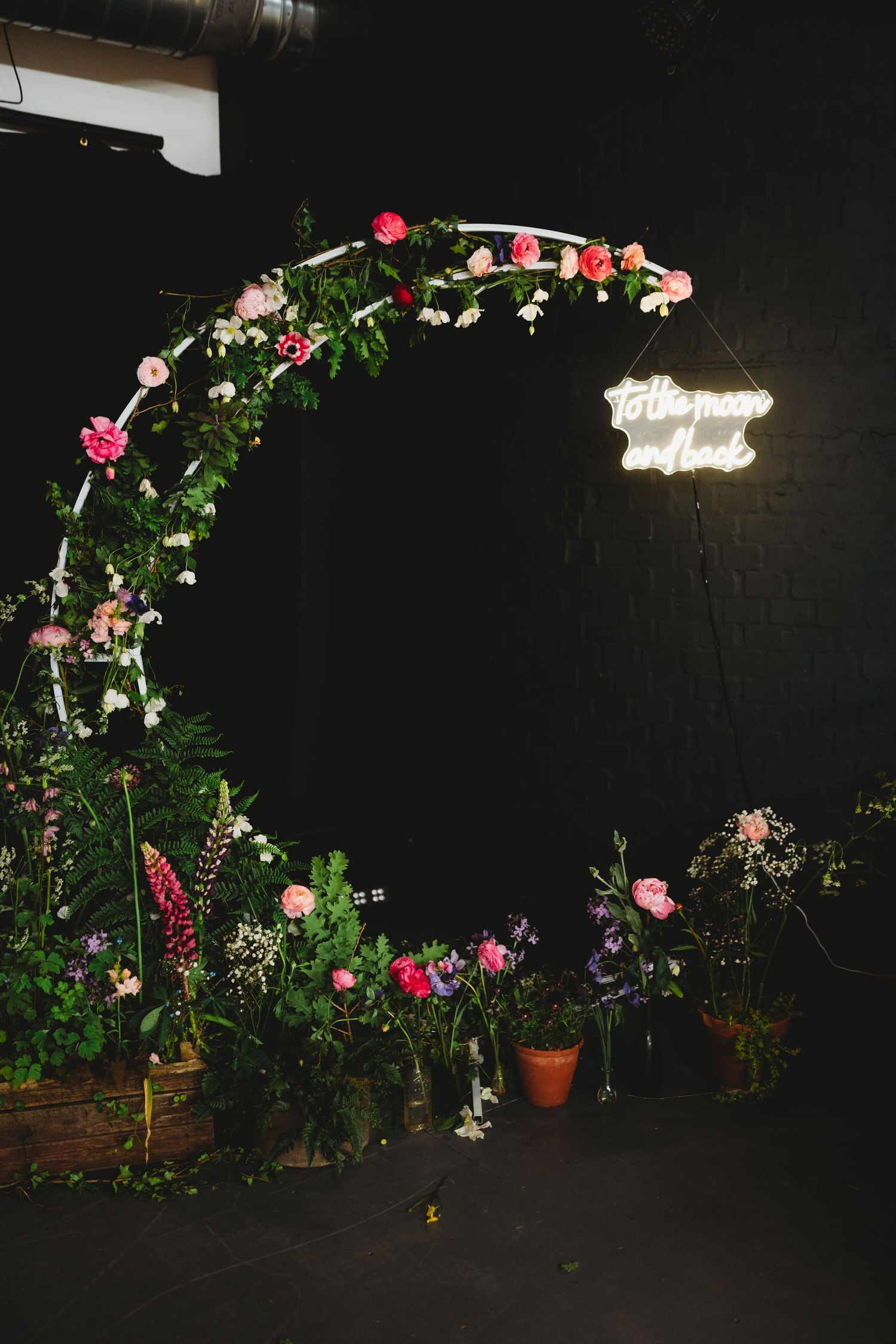 Photographers capturing moments during a wedding preparation session in a bright indoor setting.
