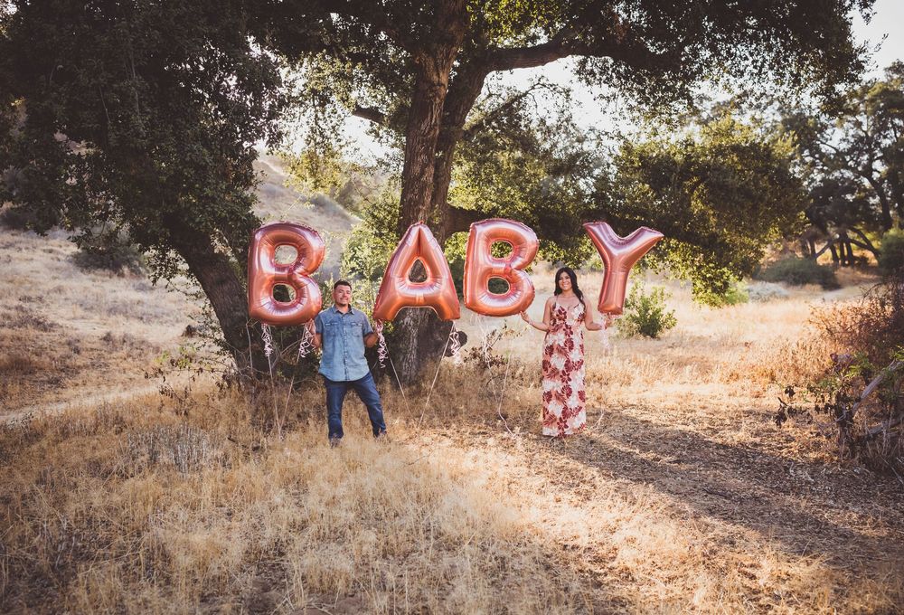 A series of outdoor photos showing a rustic wooden bench and decorative red letters spelling 'BABY' on a hillside trail.