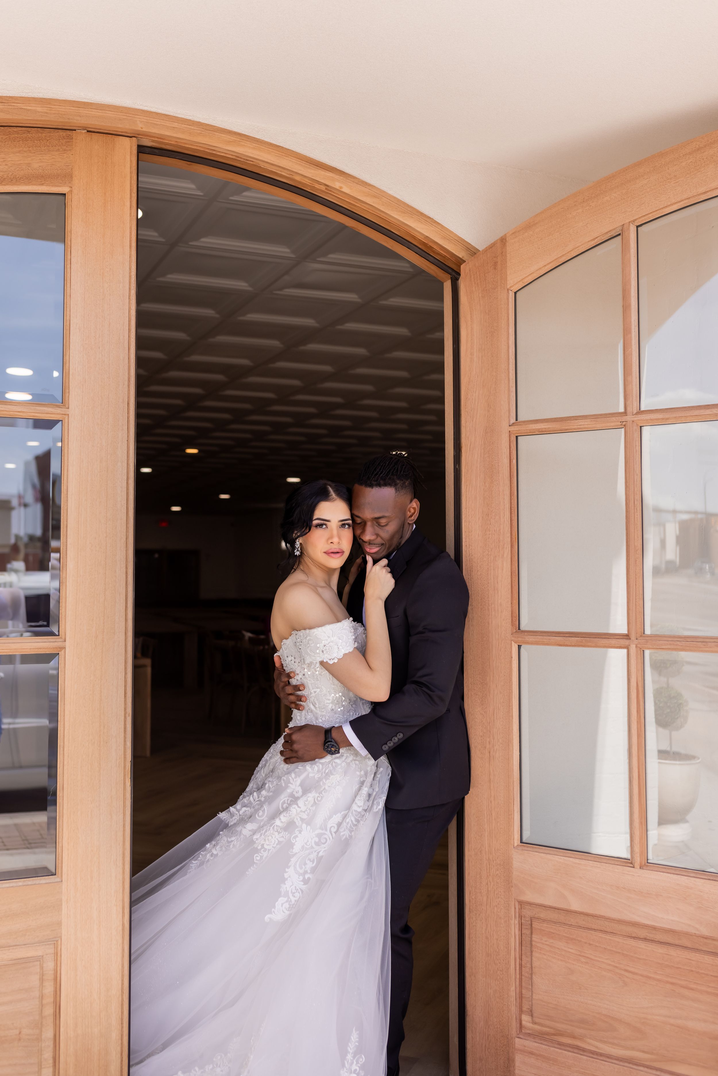 Utah wedding couple standing in wooden doorway, elegant bridal portrait with modern architecture