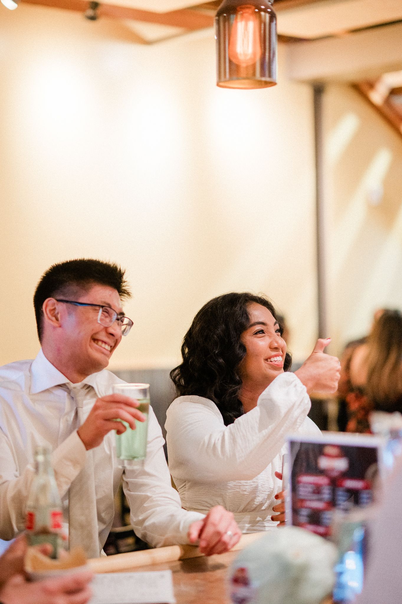 Wedding couple laughing and enjoying conversation and beer at their Bainbridge Brewing reception