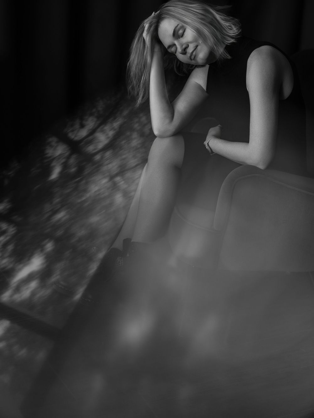 Artistic black and white portrait series showing a person in contemplative poses with dramatic shadows and lighting.