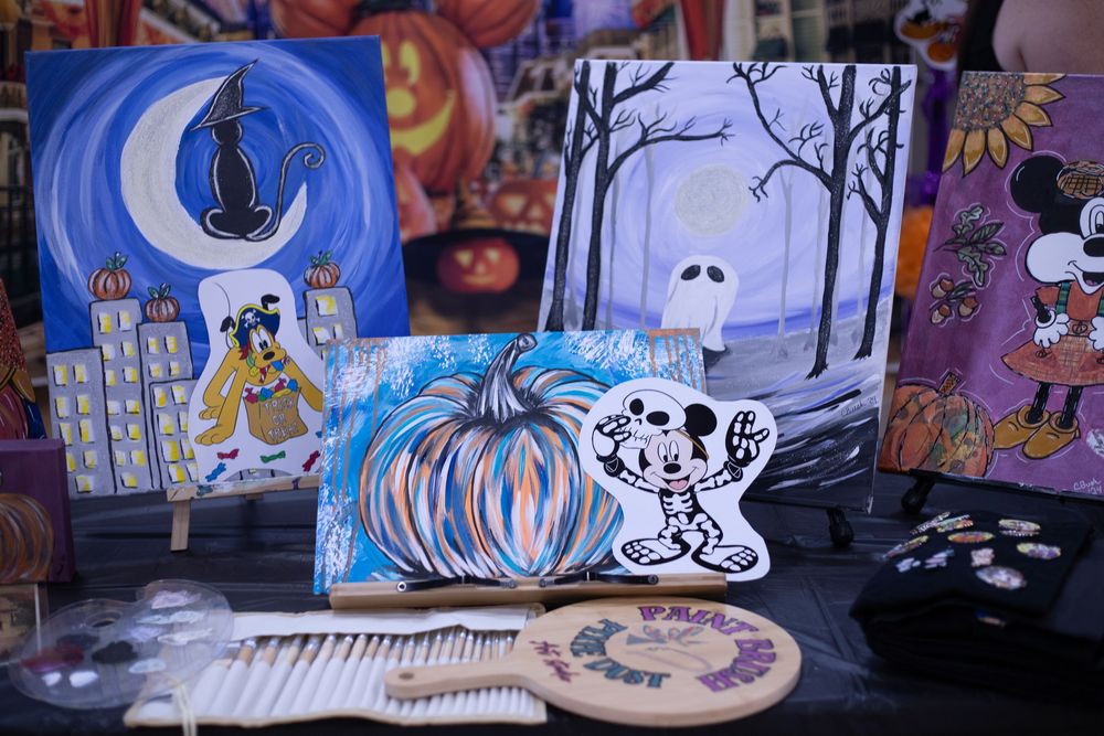 A collection of colorful murals and street art pieces displayed on walls featuring whimsical characters and designs.
