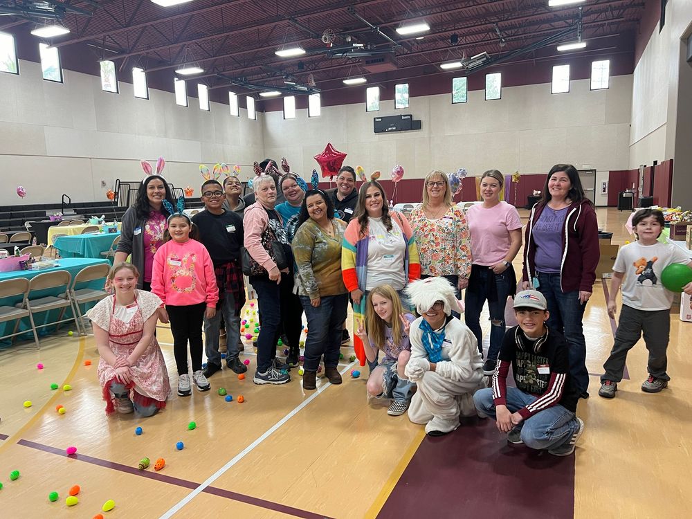 A group of seniors participating in a recreational activity with colorful balls in a large indoor gymnasium.