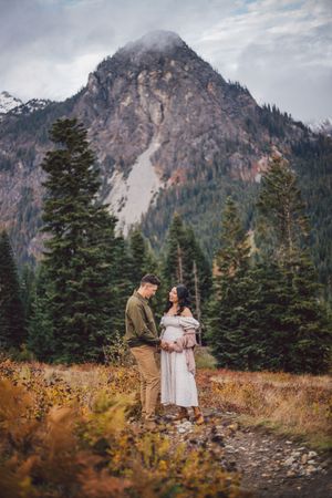 Couple standing together during their adventure and maternity photoshoot at Snoqualmie Pass near Seattle, Washington