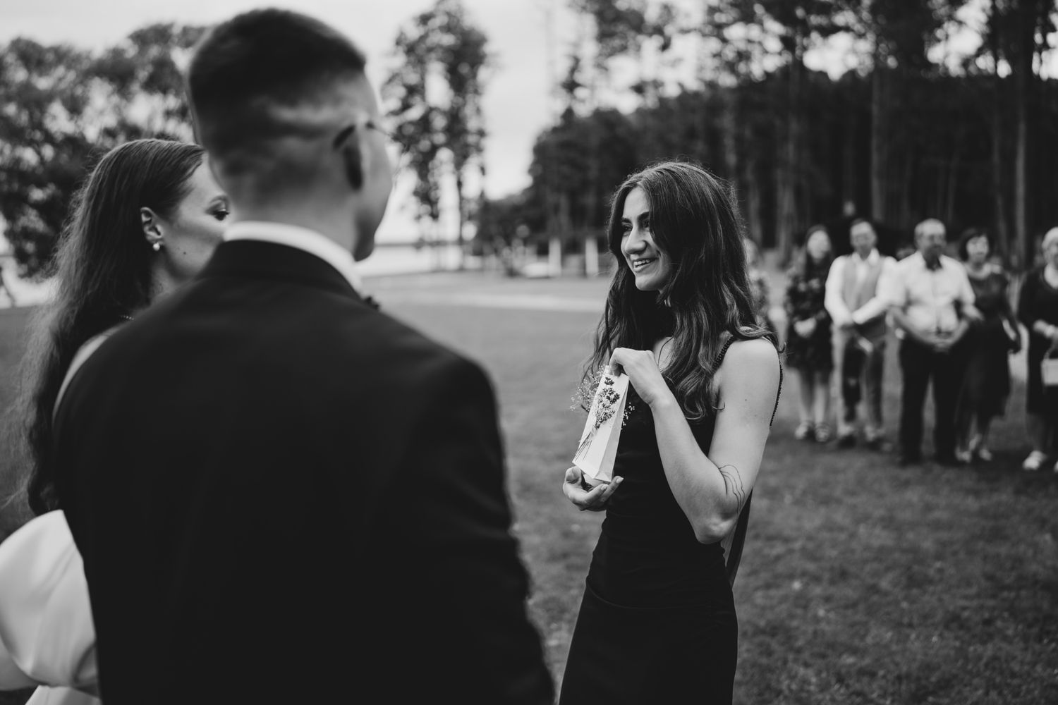 Guests engaged in conversation during an outdoor wedding reception.