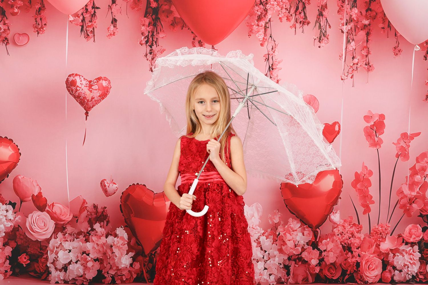Valentine's themed photo with red dress, white umbrella, and heart balloons against pink floral backdrop.