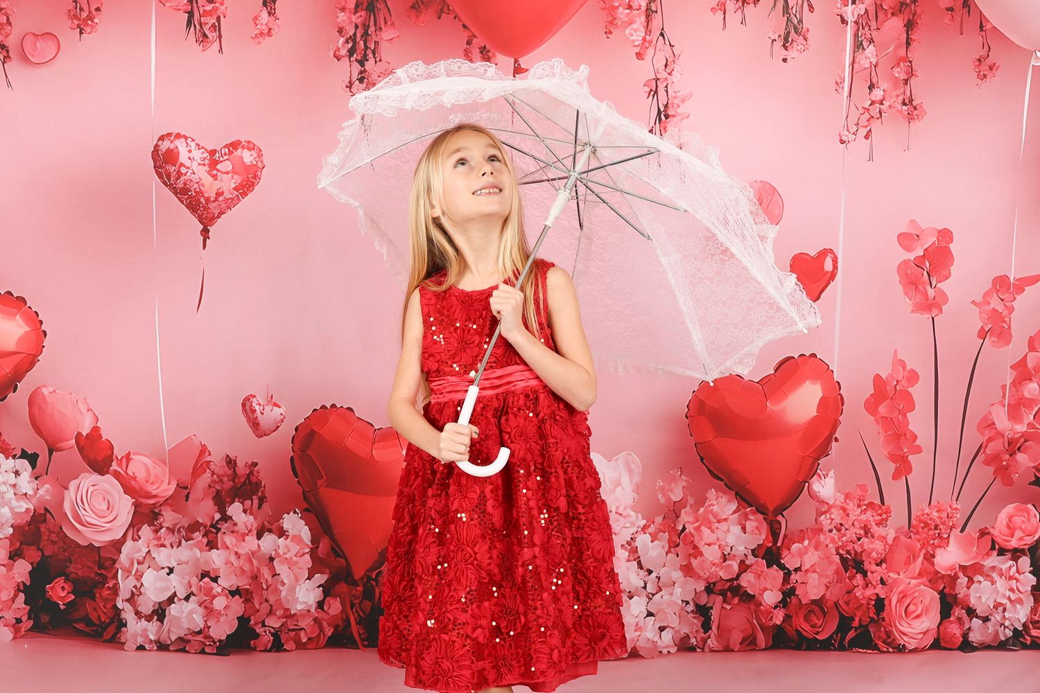 Whimsical Valentine's scene with white lace umbrella and red heart balloons on pink backdrop.