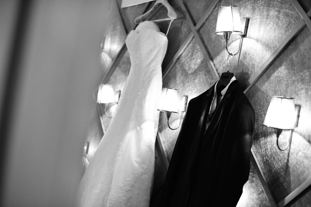 Black and white sequence showing hands holding a wine glass in different positions.