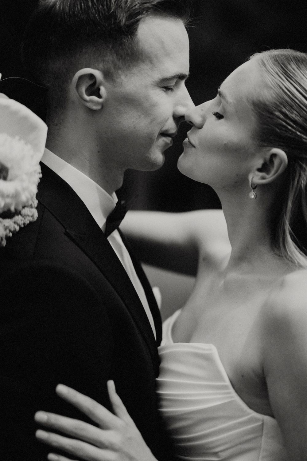 Intimate black and white close-up of a tender moment between newlyweds.