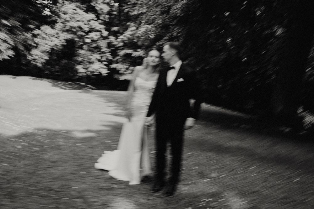 Artistic black and white wedding photo showing silhouettes against a natural backdrop.