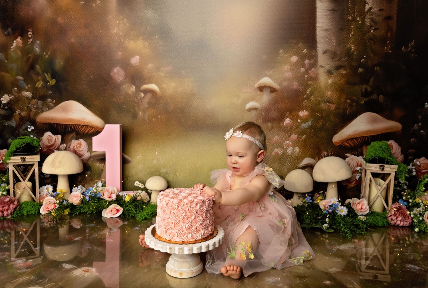 Concord NH cake smash photography of a one-year-old girl with pink cake, whimsical woodland first birthday studio portrait.