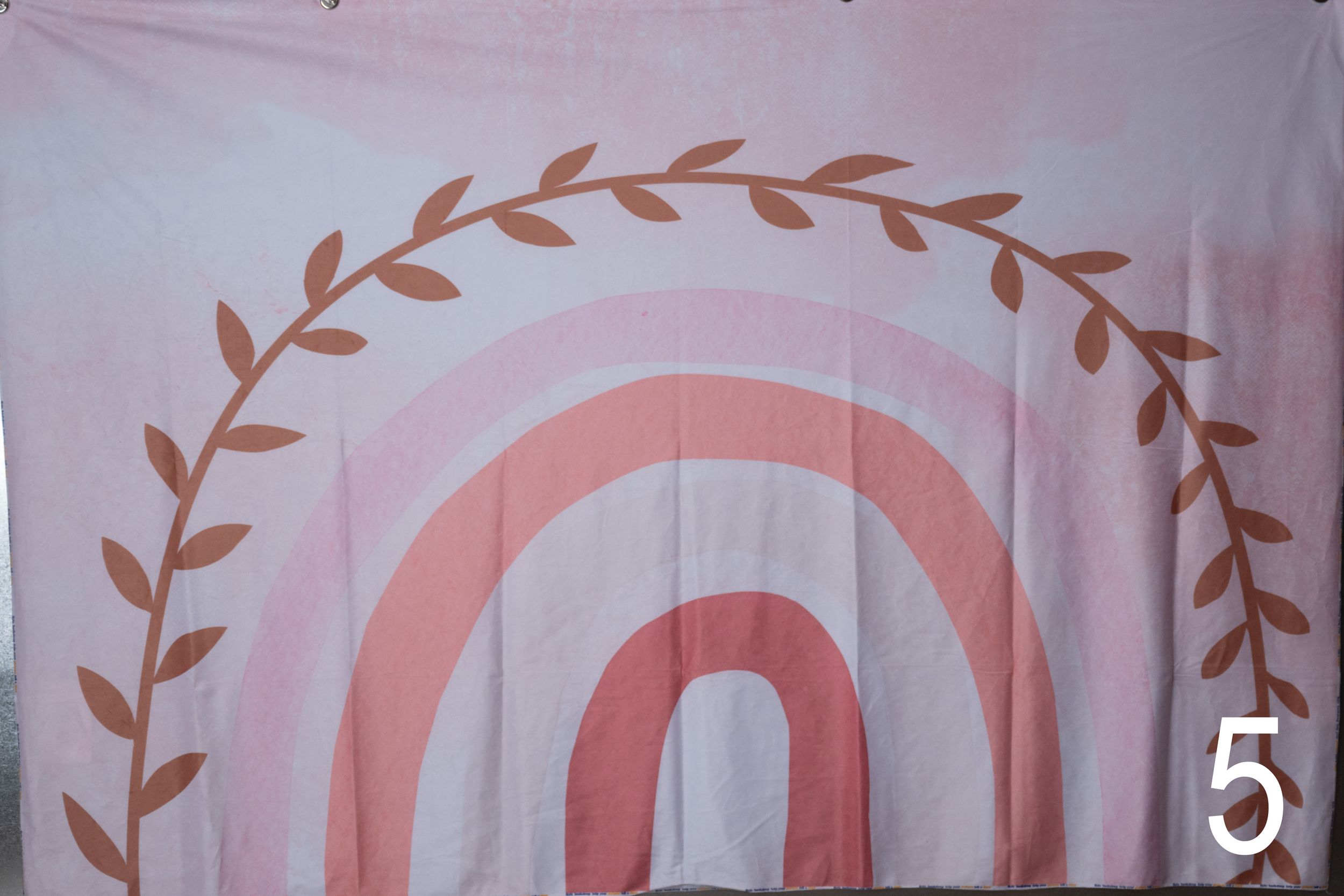 Pink and white floral pattern with delicate leaf motifs repeats across a decorative background.
