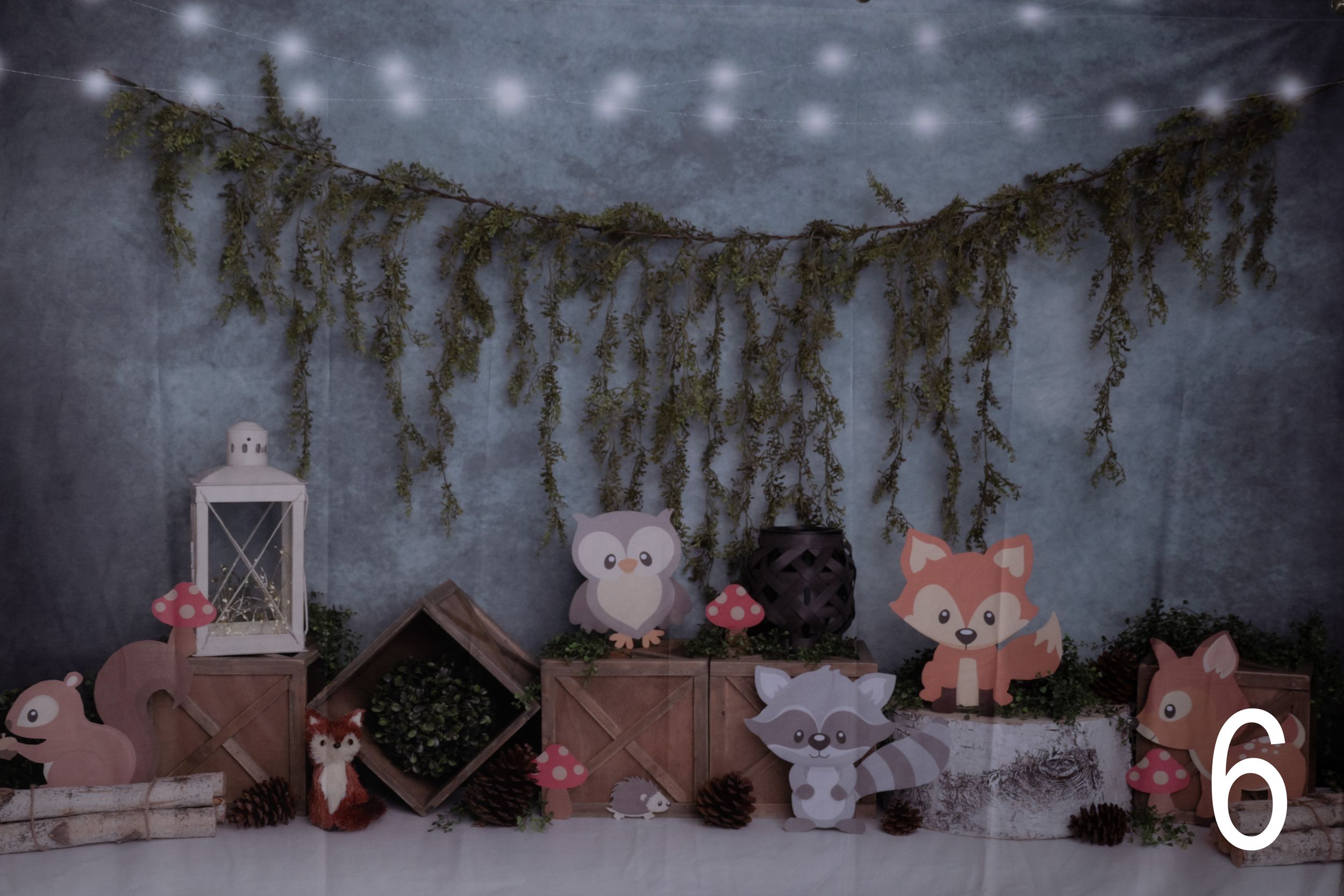 Winter wonderland scene with plush animals and twinkling lights against a snowy backdrop.