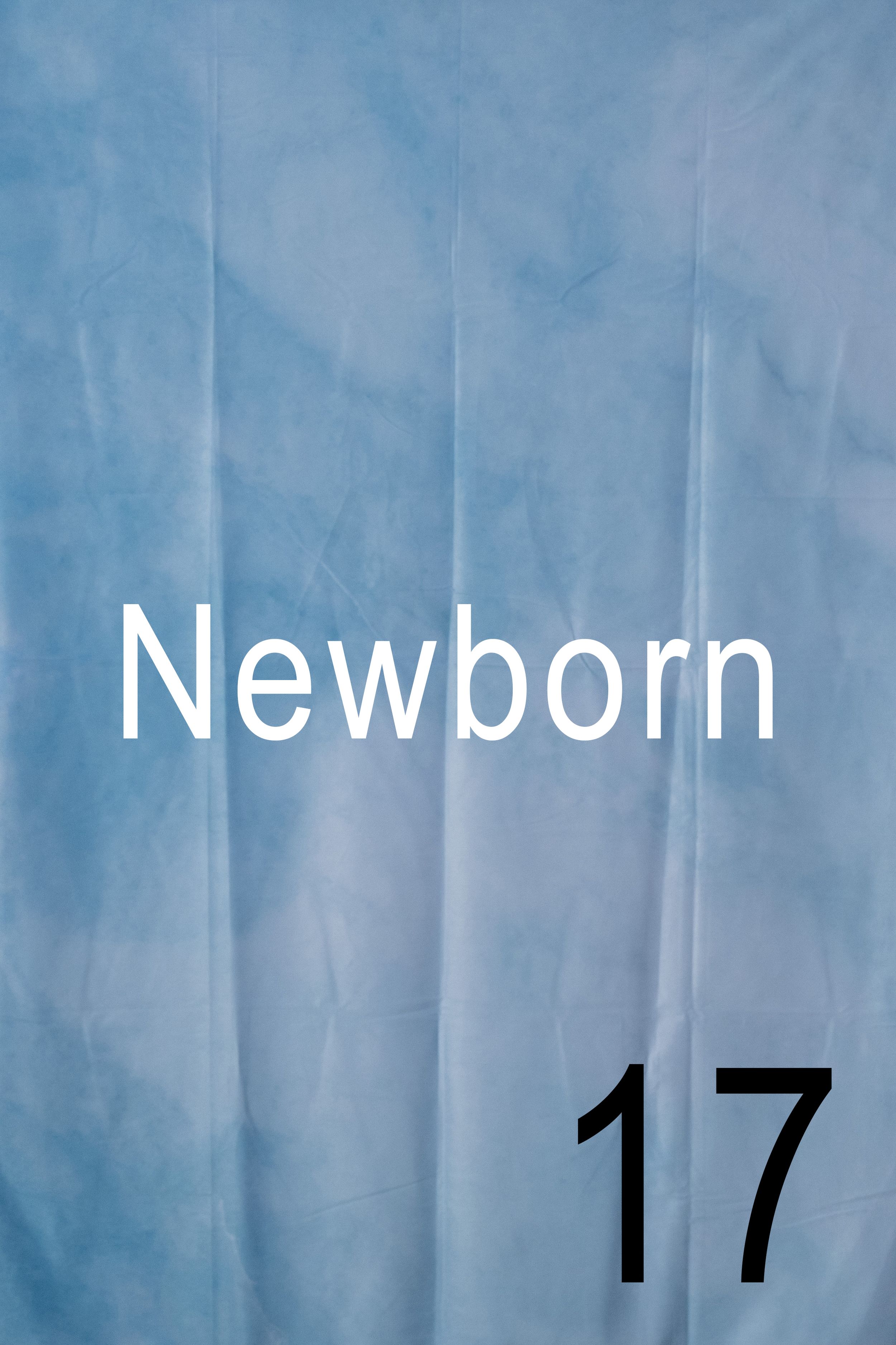 A blue hospital curtain or divider with the text 'Newborn 17' displayed in white and black lettering.
