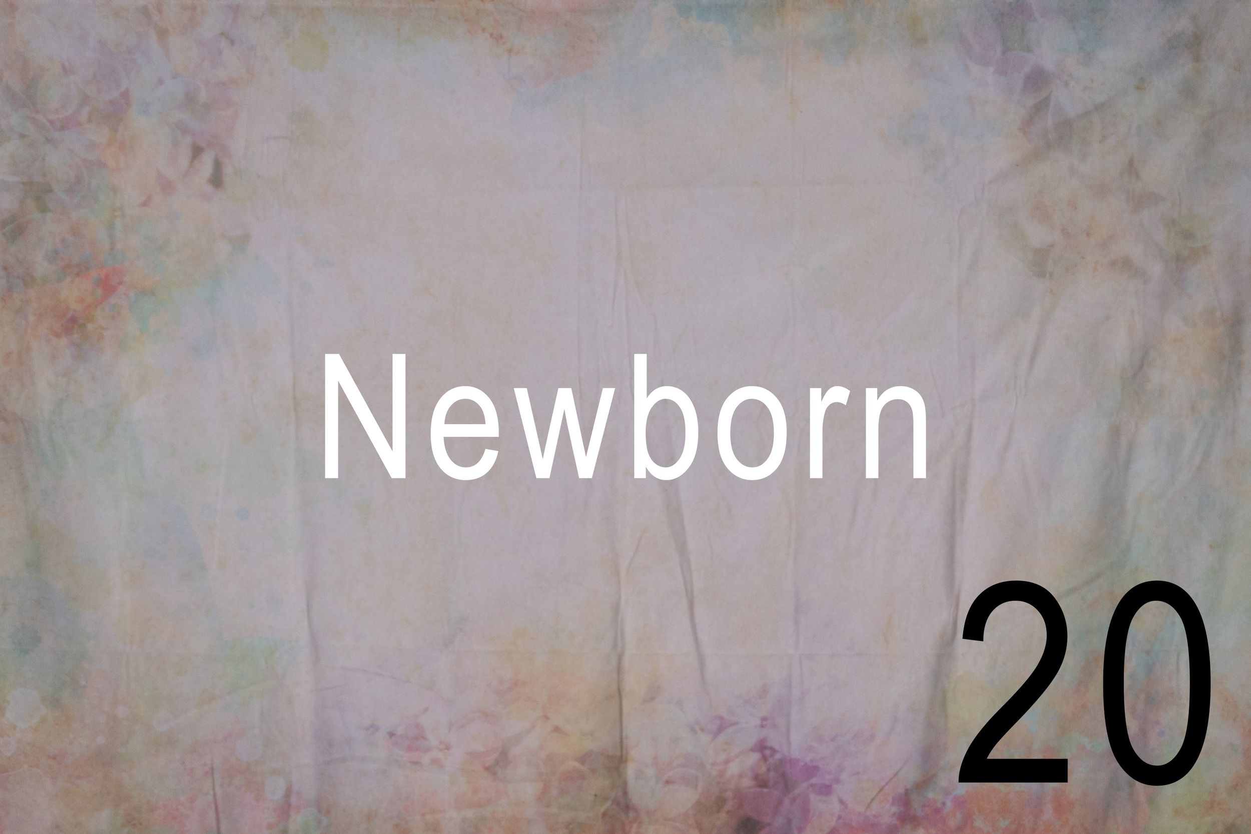 A newborn baby wrapped in a white blanket lies sleeping peacefully on a soft textured surface.
