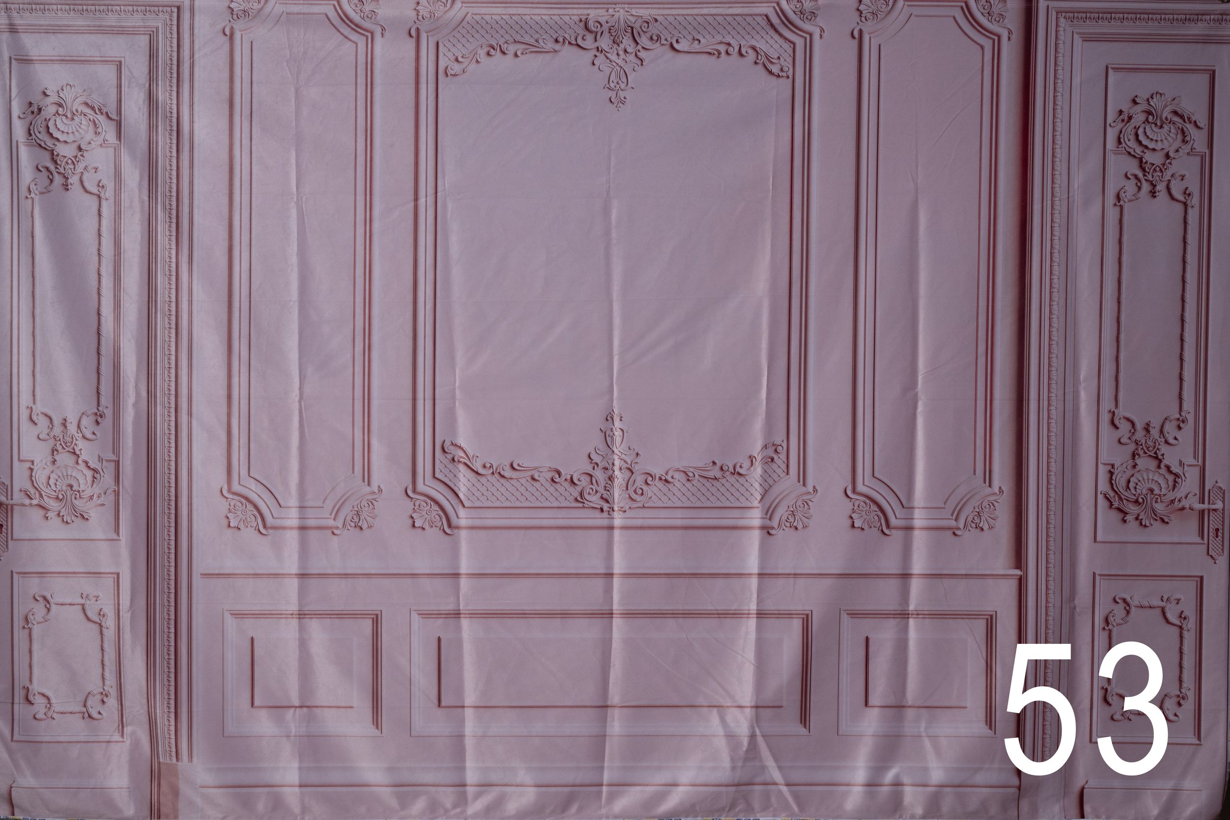 Elegant white ornate wall molding and architectural details in a classical interior design style.