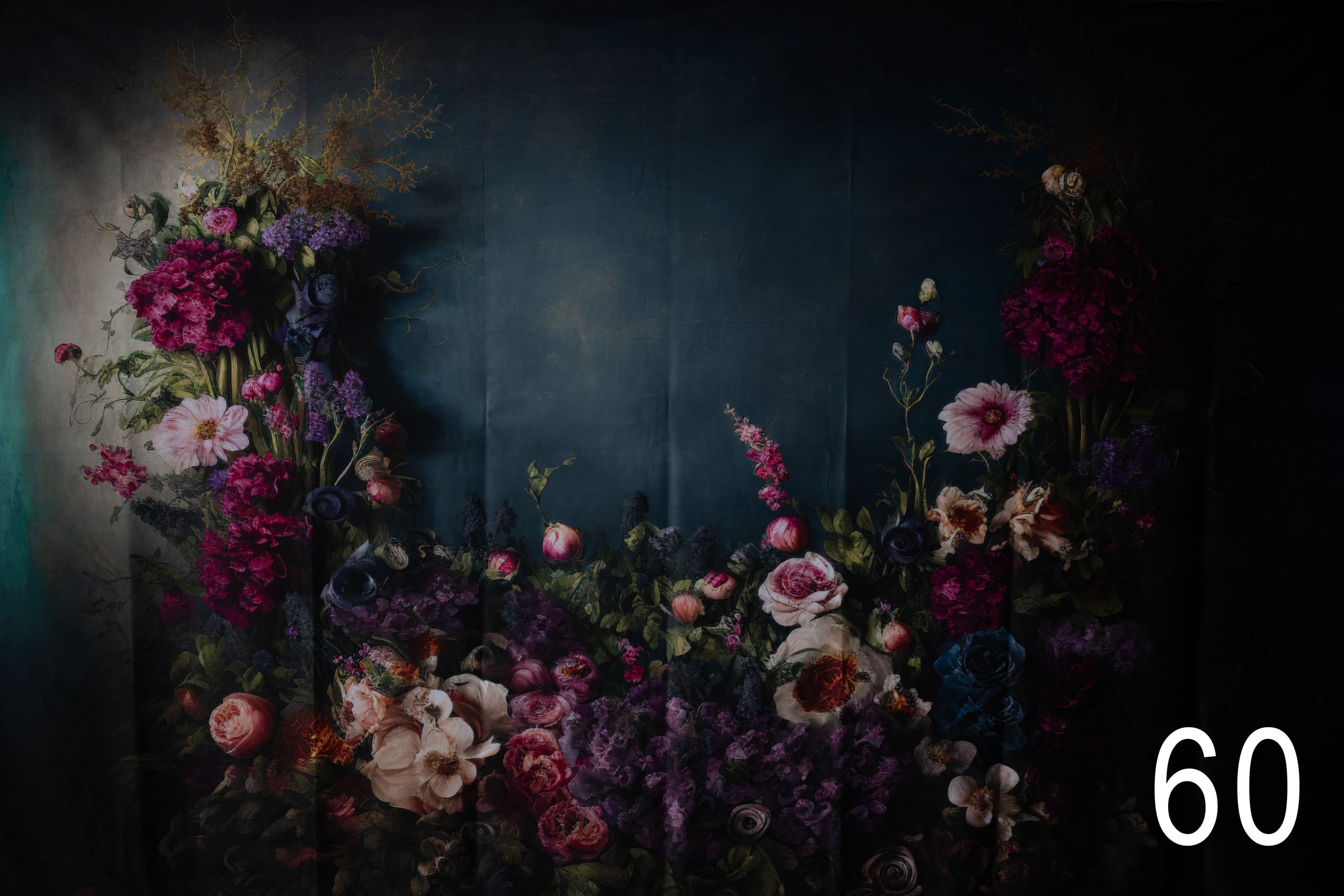 Dark and moody floral still life photography with pink roses and purple flowers against a dramatic black background.
