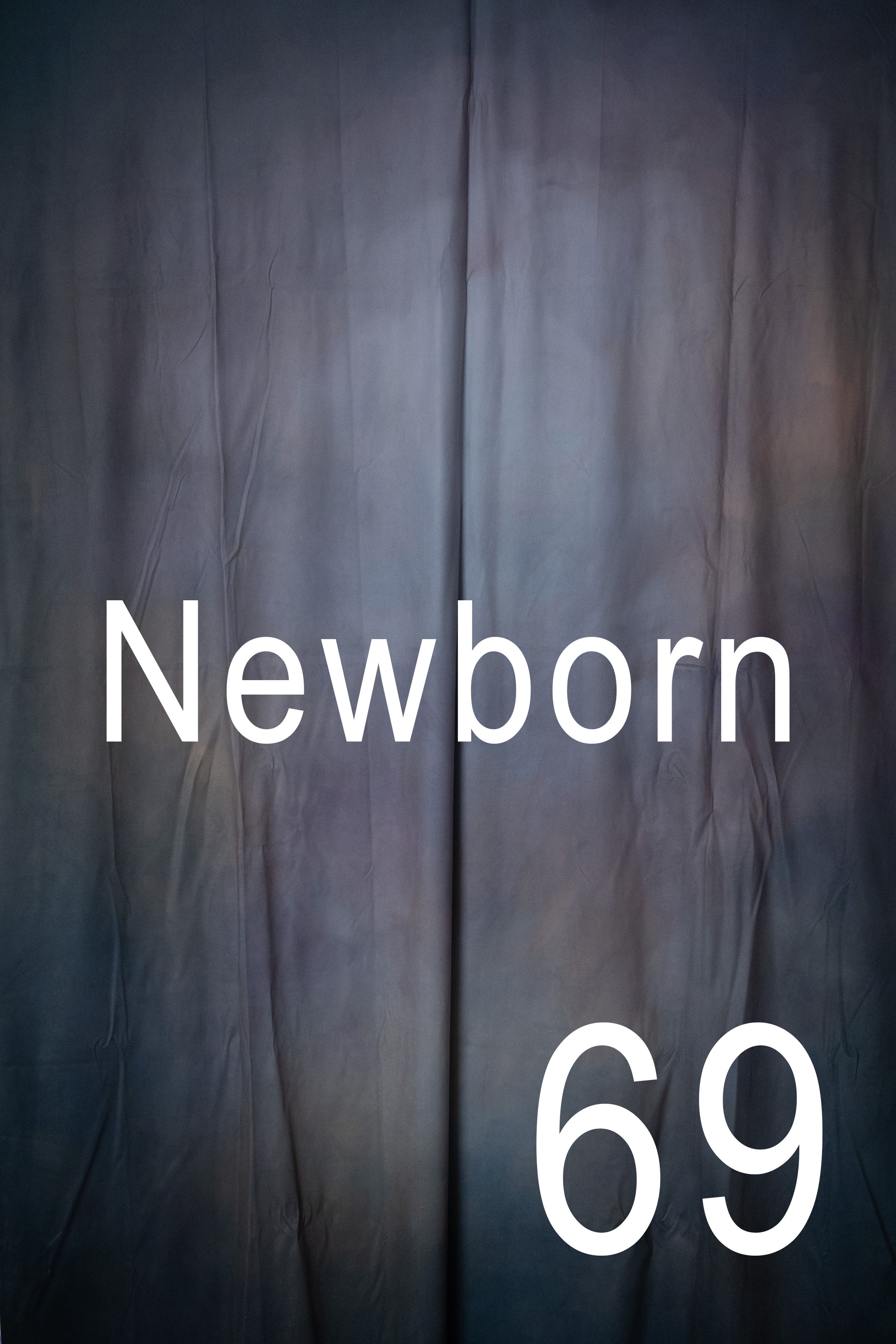 Abstract dark background with white text spelling 'Newborn' against a blurred moody backdrop.