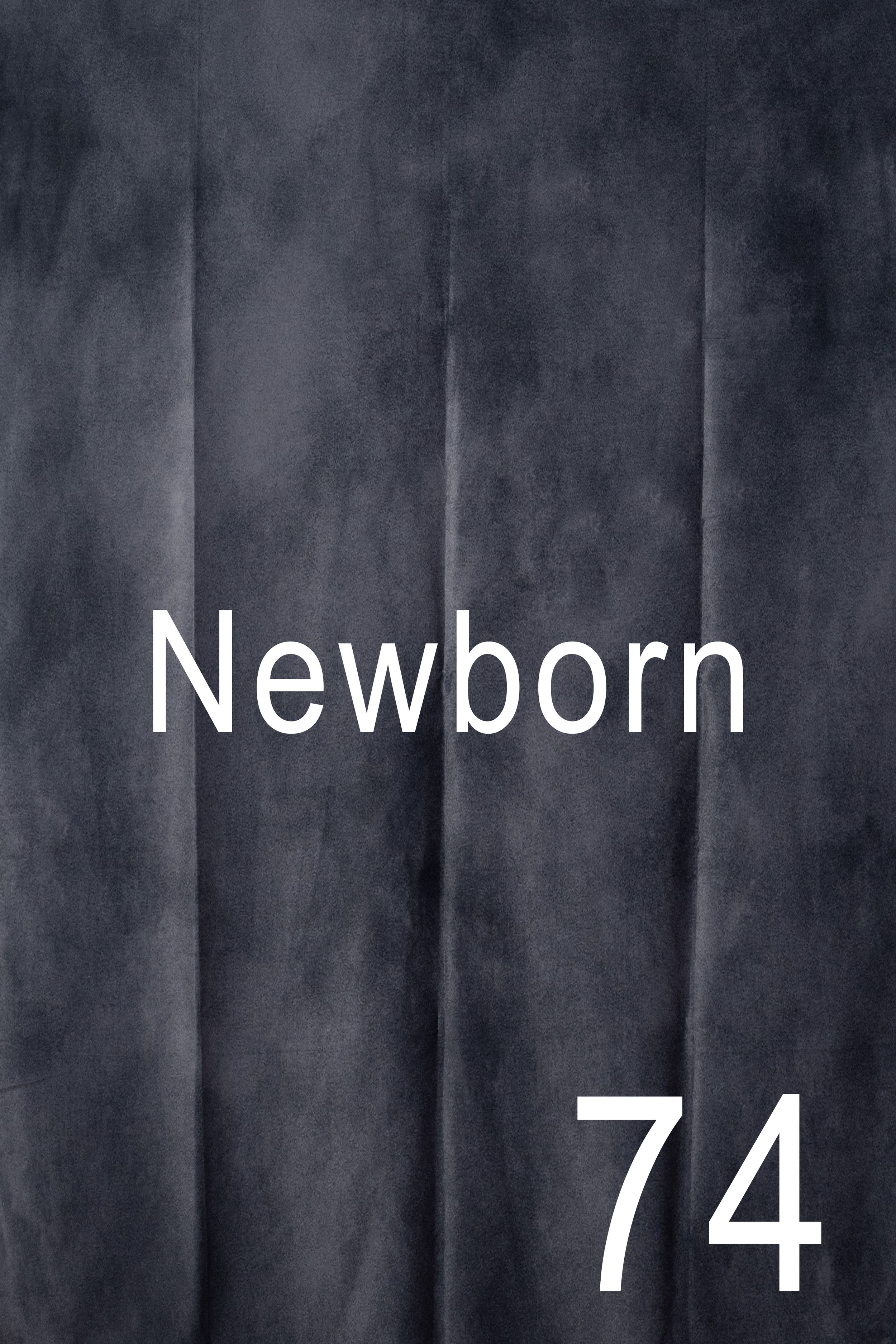 White text reading 'Newborn 74' on a dark textured background with vertical stripes.