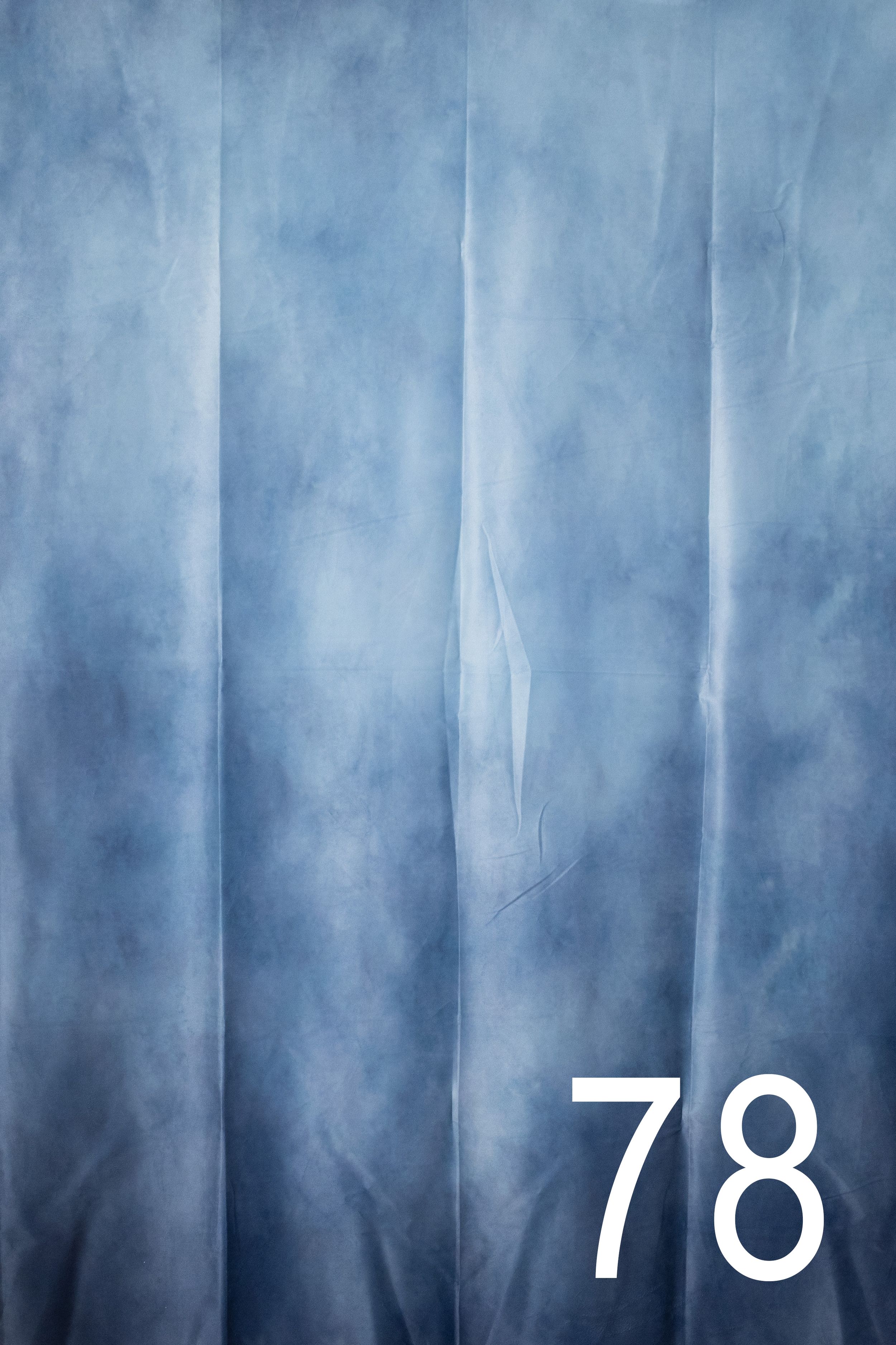Abstract vertical stripes in shades of blue and white create a misty, atmospheric pattern with the number 70 visible.