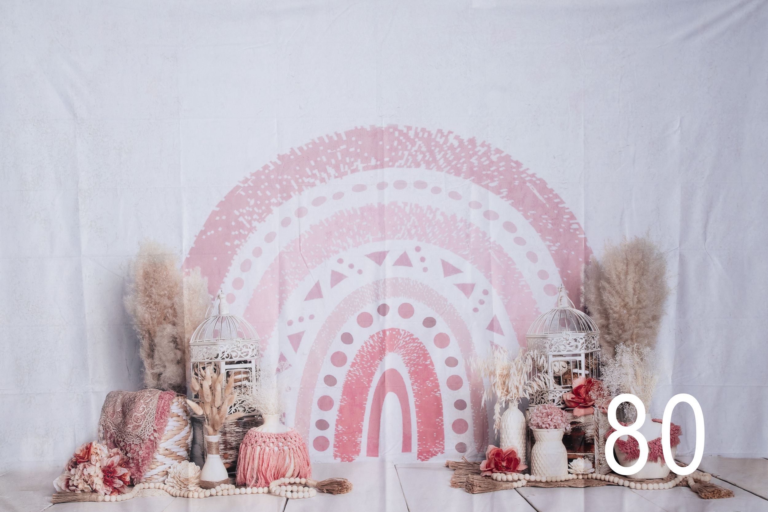 A pink and white wedding backdrop with floral decorations and a circular arch design creates an elegant ceremony setting.