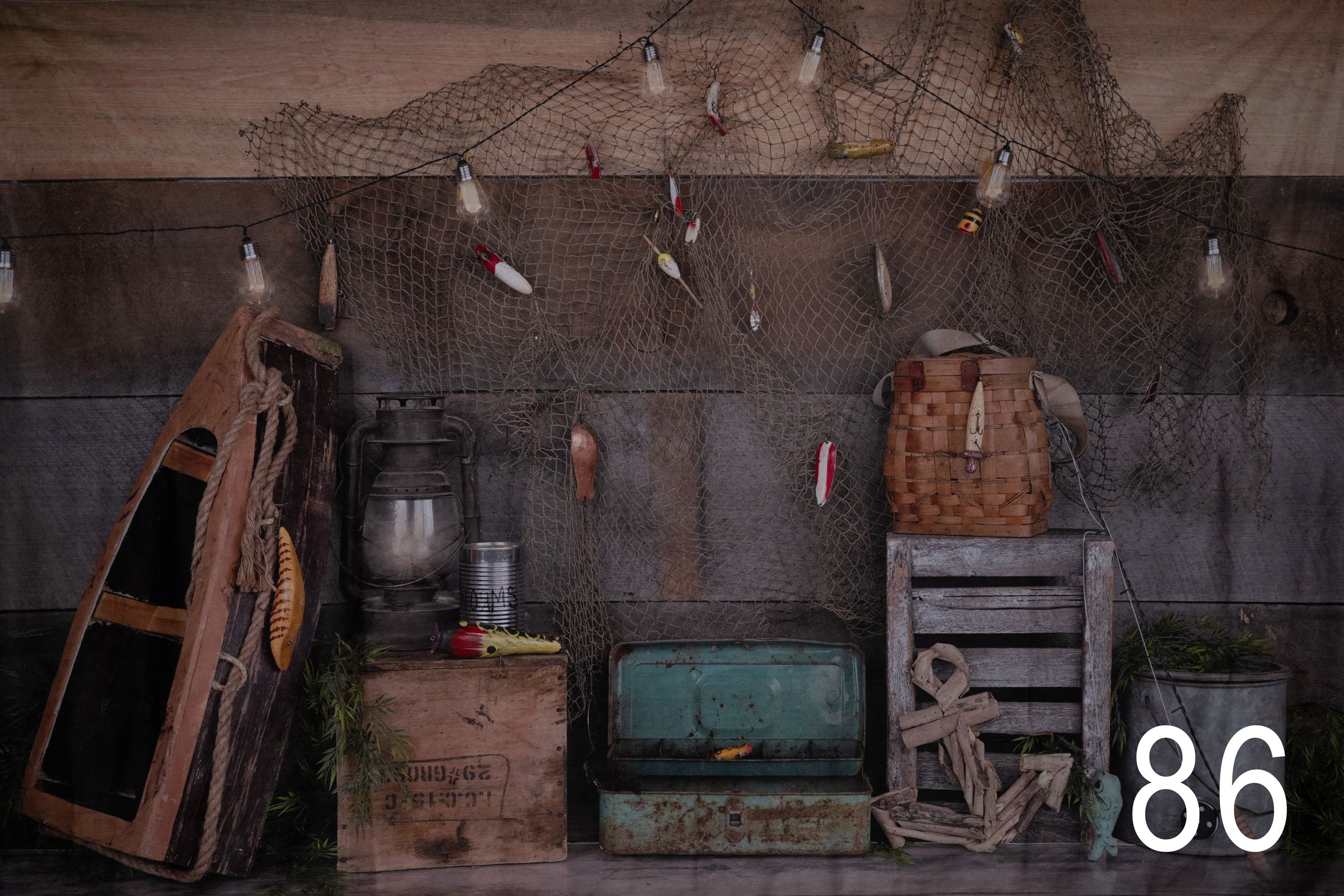 Vintage wooden furniture and antique items arranged in a rustic room with brick walls.