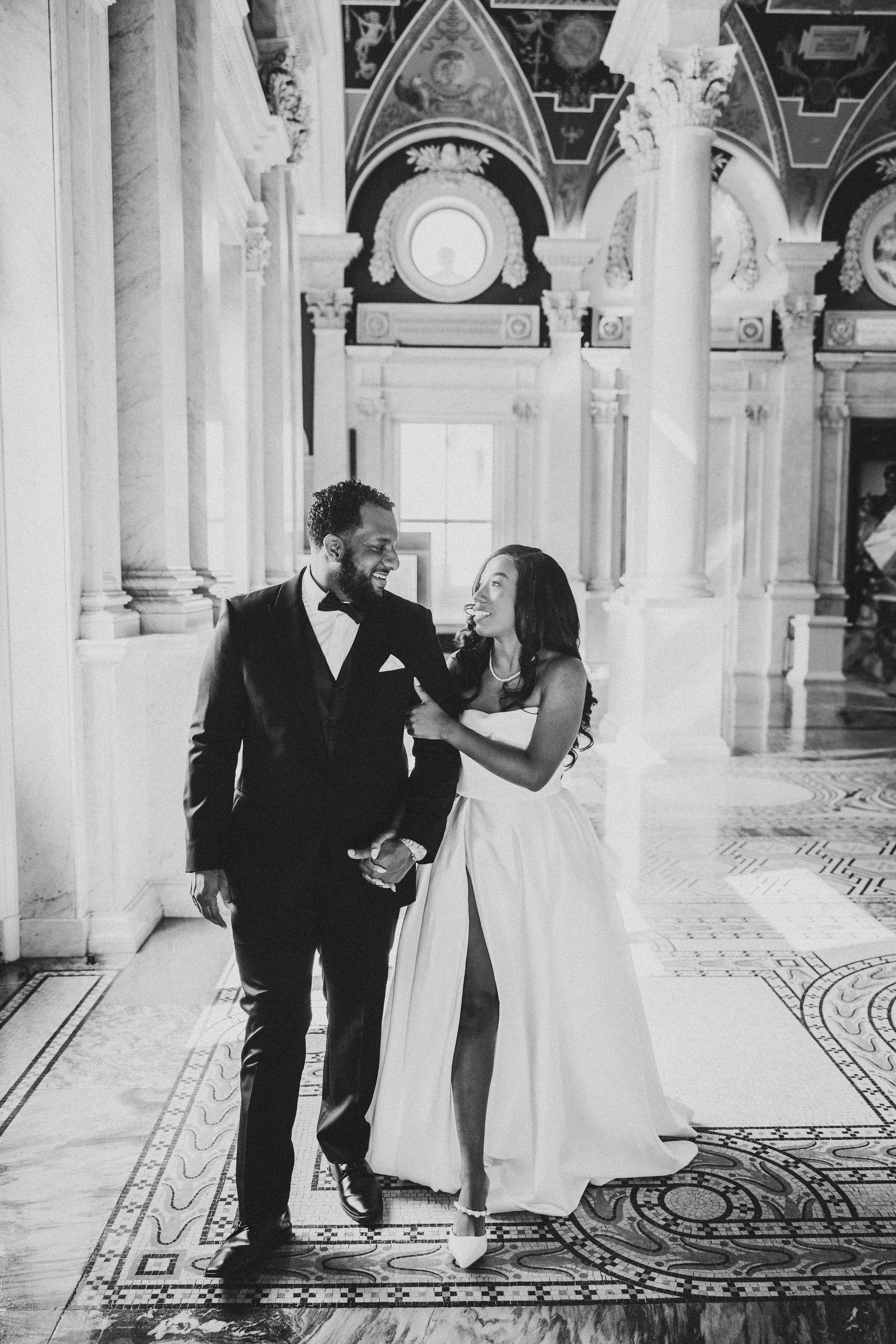 Elegant black and white wedding photos showing couple walking through a hallway with decorative floor patterns of the Library of Congress