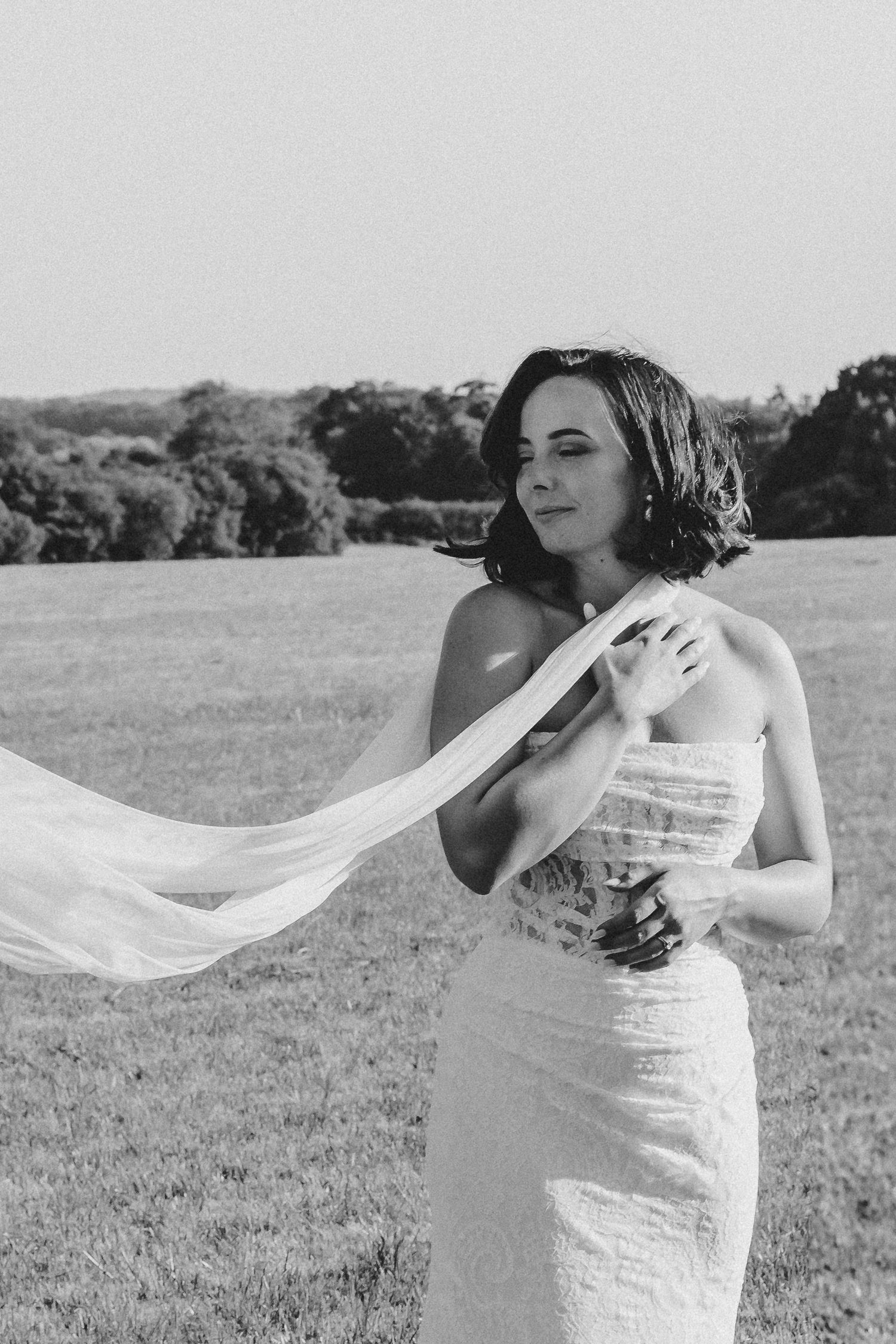 Romantic black and white portrait of the bride, elegant and serene.