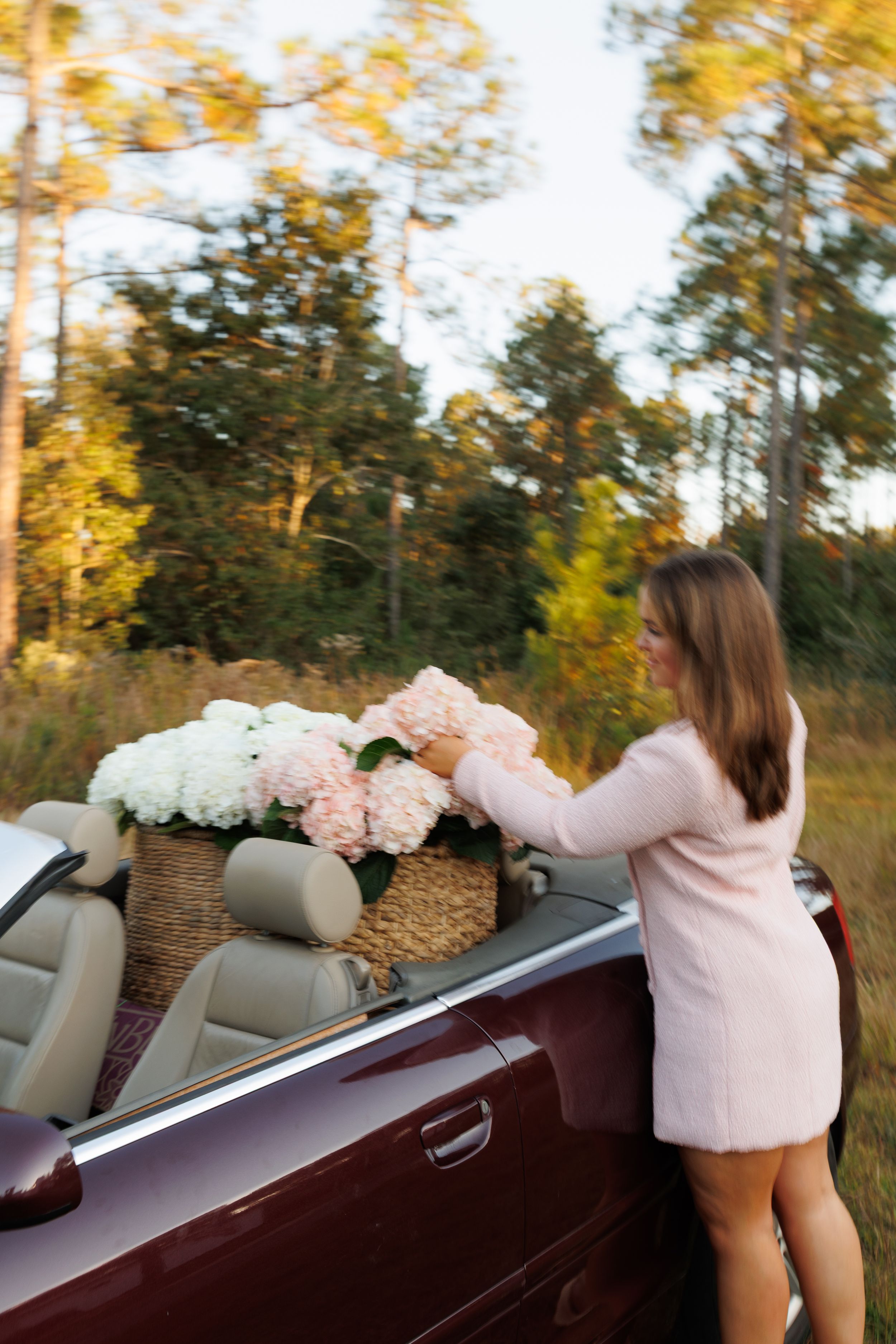 A sequence of photos showing flowers being arranged in a basket on the back of a convertible car at sunset.