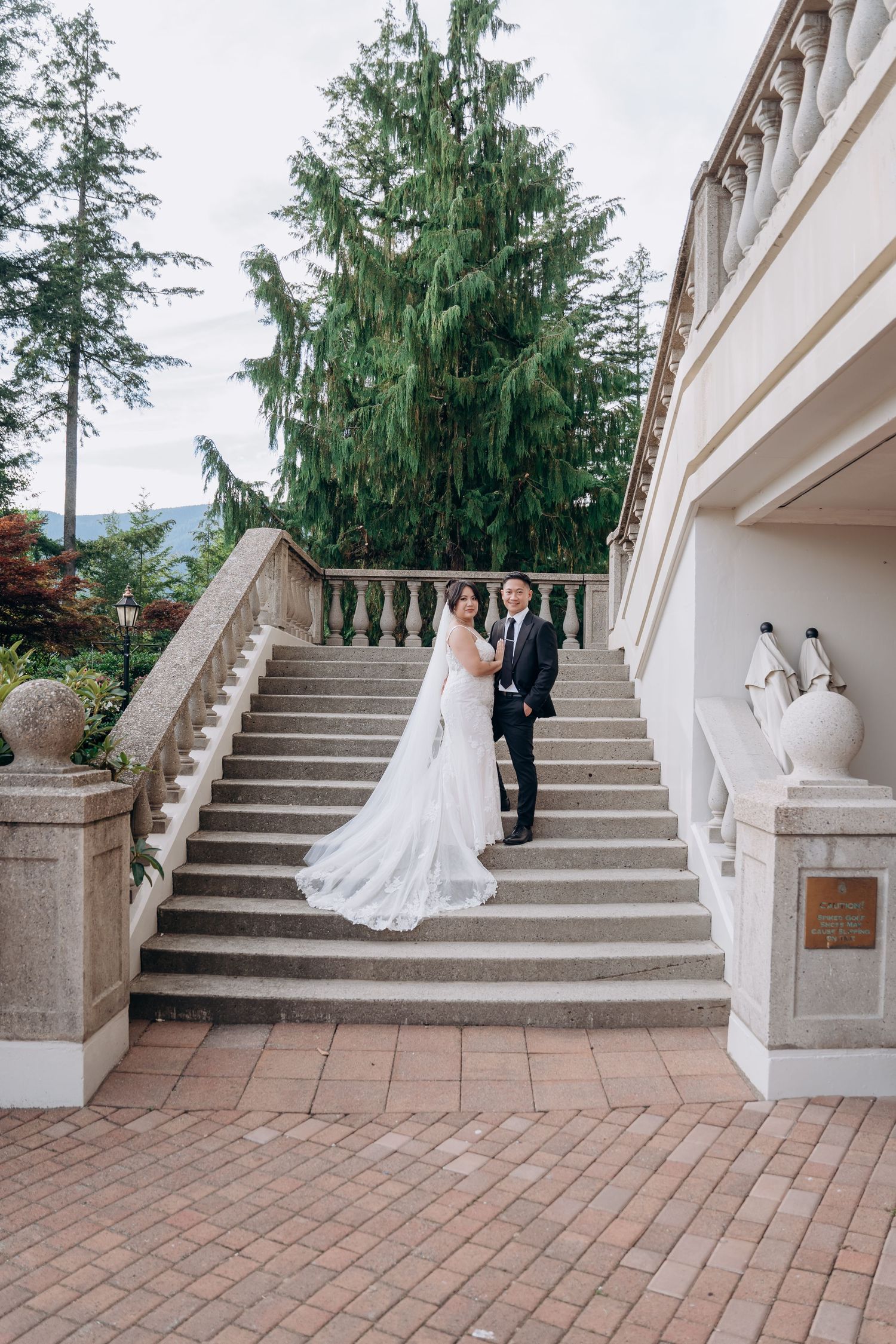 A wedding couple poses on elegant white stone stairs in a sequence of five connected photos showing different angles.
