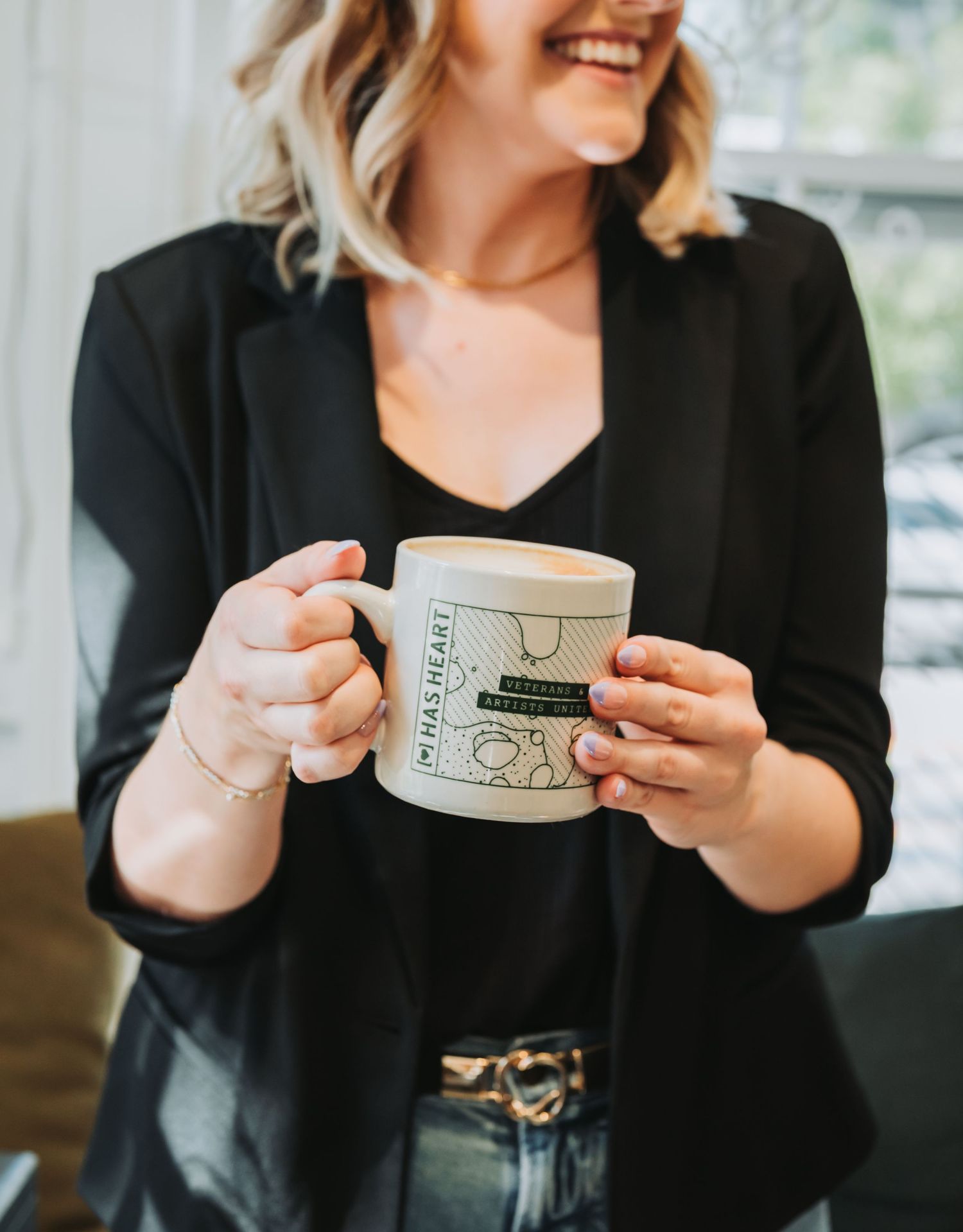 A sequence of photos showing hands holding a coffee mug with illustrations, demonstrating different angles of the cup.