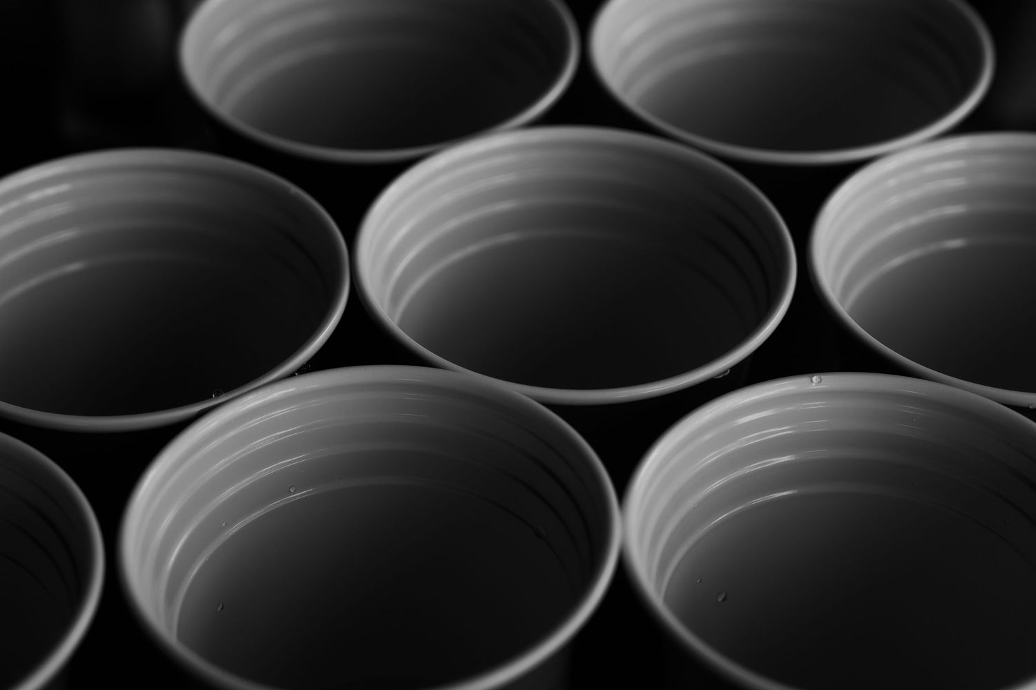 Close-up of multiple empty ceramic bowls arranged in black and white.
