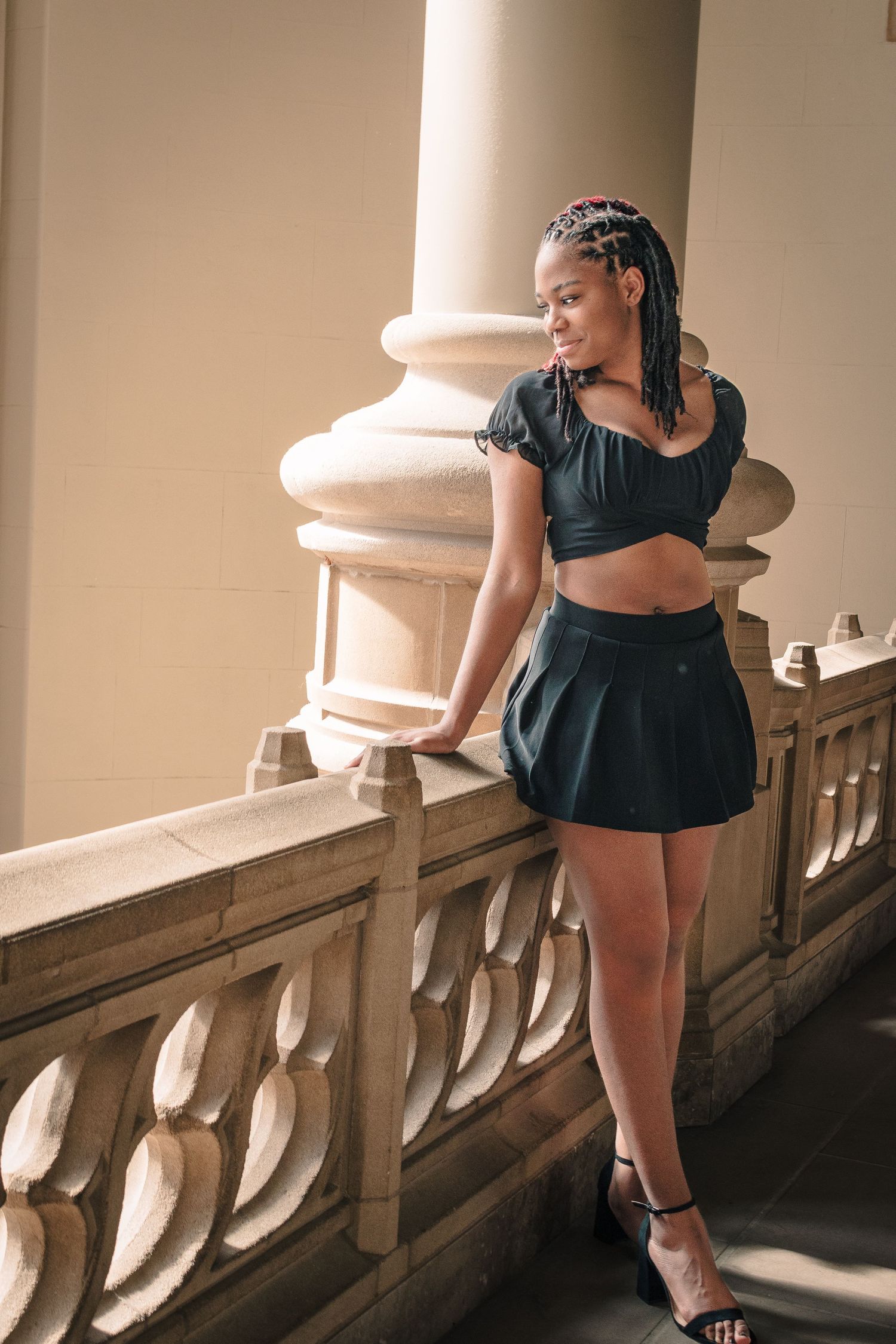 Seattle senior in graduation photo at University of Washington in black dress.