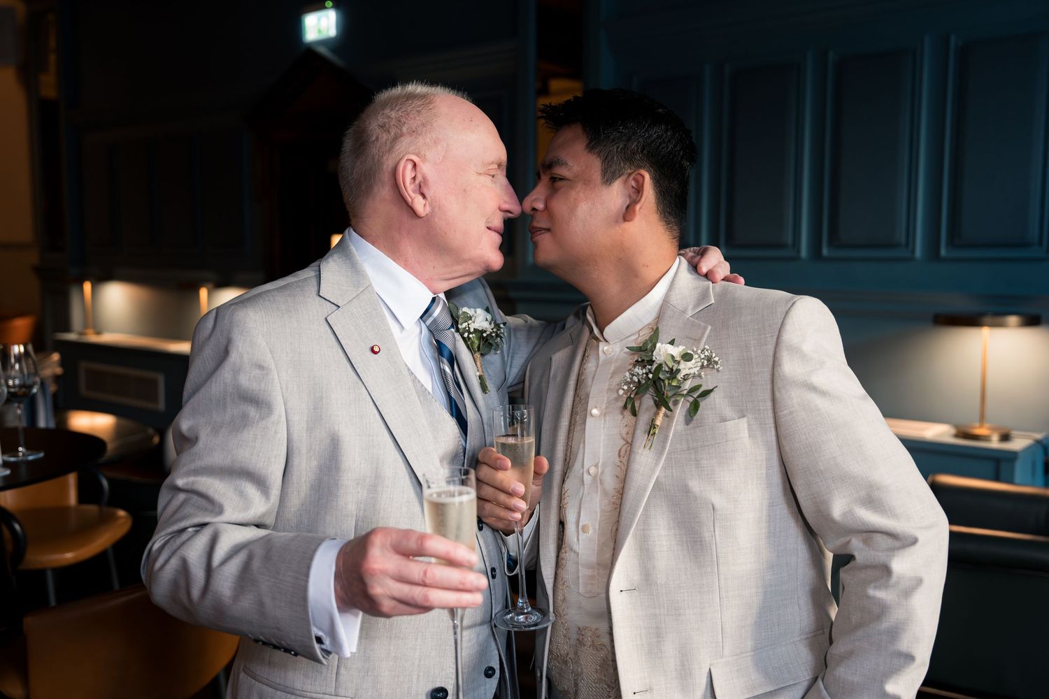 A romantic wedding photo series showing a couple in formal attire embracing outdoors against a natural backdrop.