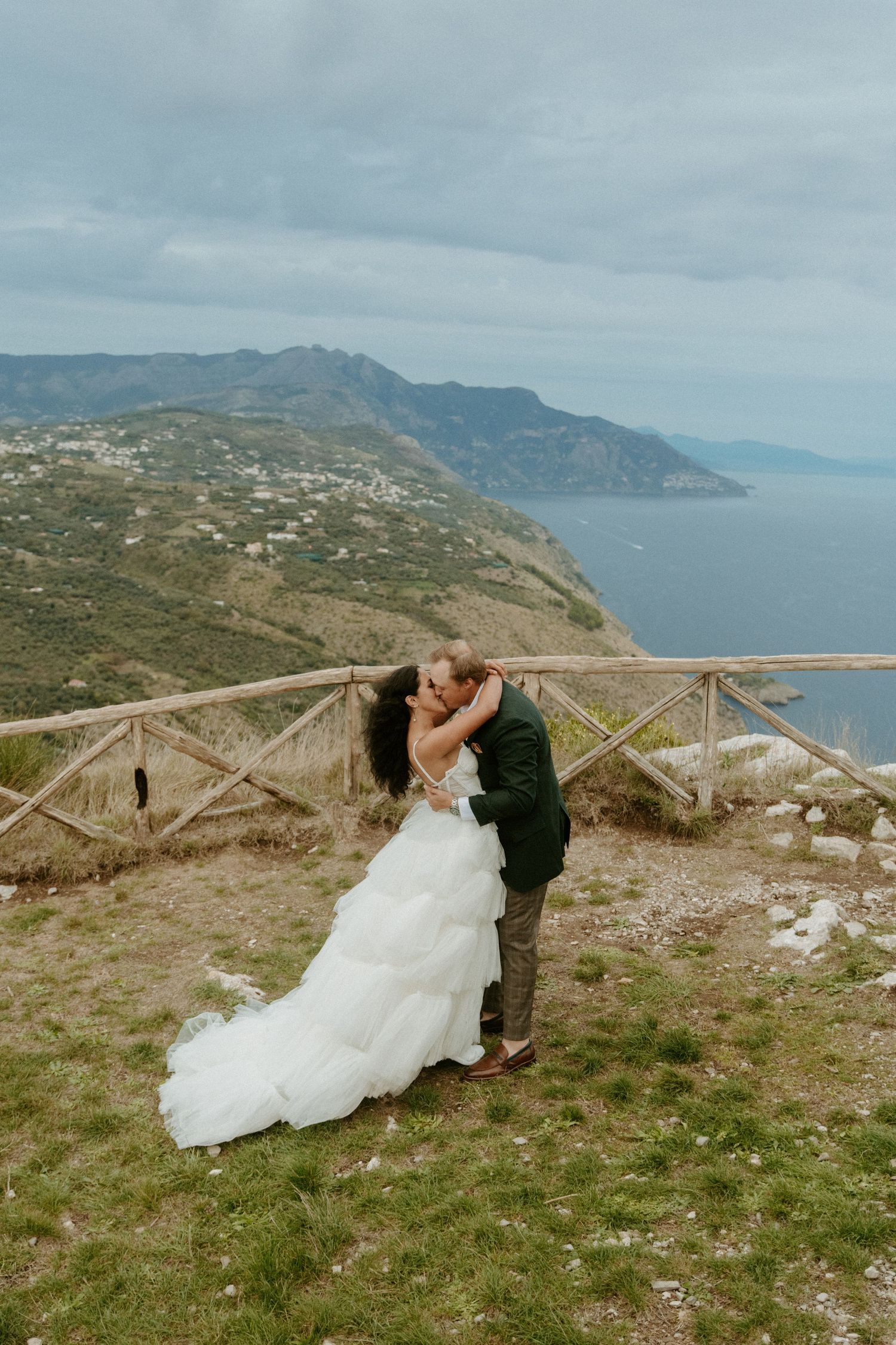 Newlywed couple celebrates joyfully with confetti falling around them during their wedding reception.