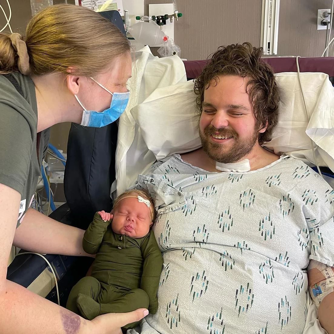 A heartwarming scene in a hospital room as a newborn baby is cradled while receiving care.