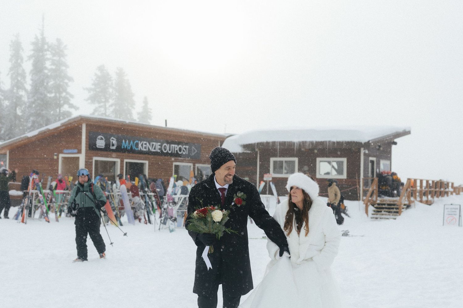 bride and groom walk through mountain village in Revelstoke after their elopement