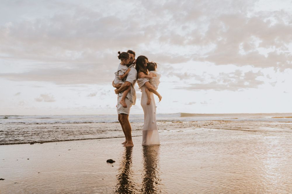 Beach family photography in Bali with an 
ocean backdrop