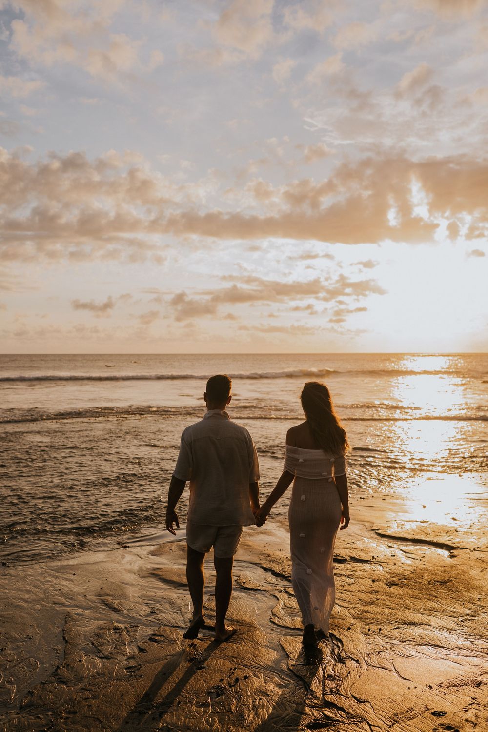 Beach family photography in Bali with an 
ocean backdrop