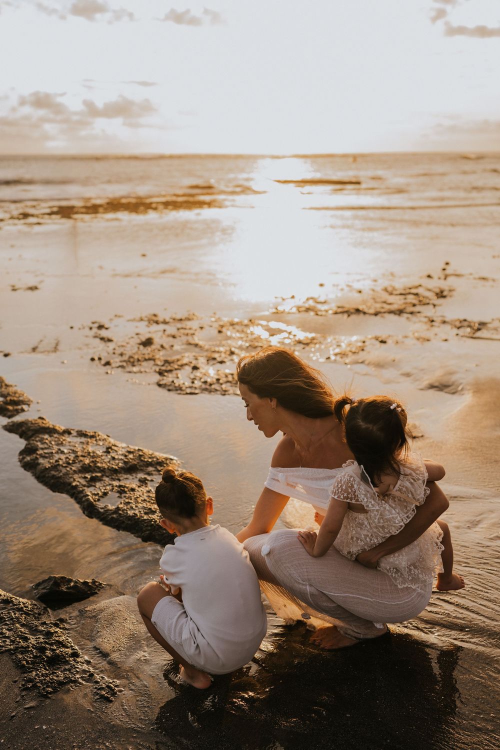 Beach family photography in Bali with an 
ocean backdrop