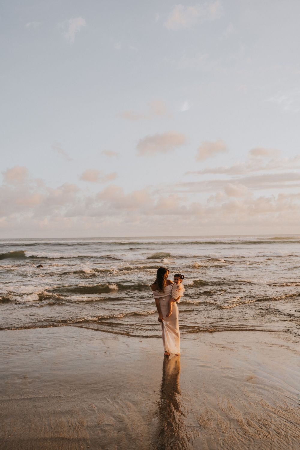 Beach family photography in Bali with an 
ocean backdrop