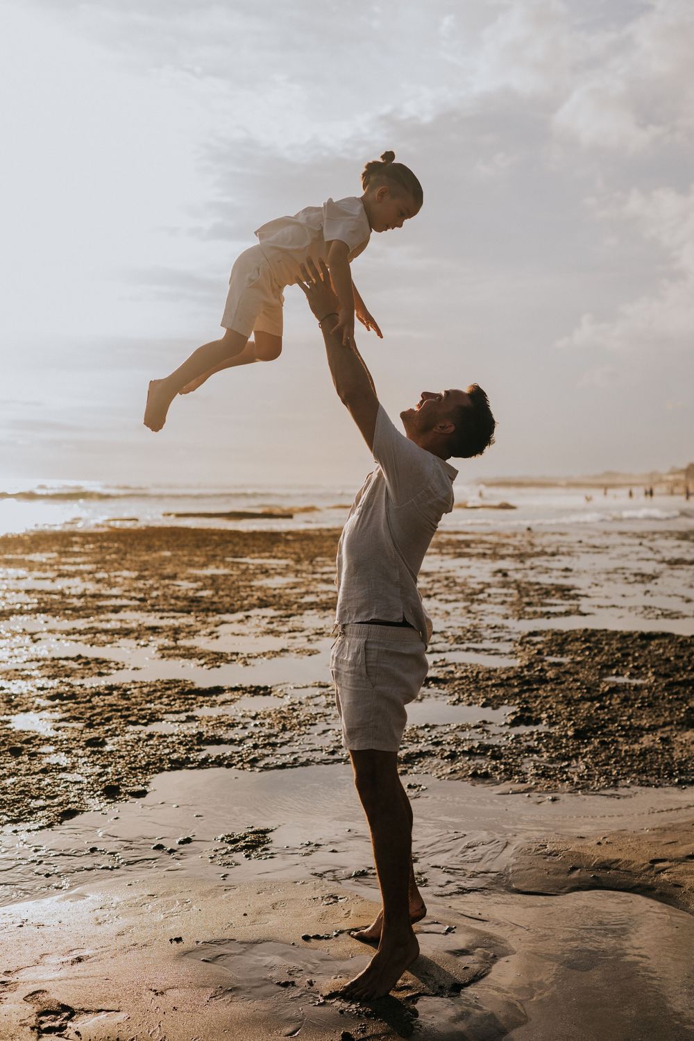 Beach family photography in Bali with an 
ocean backdrop